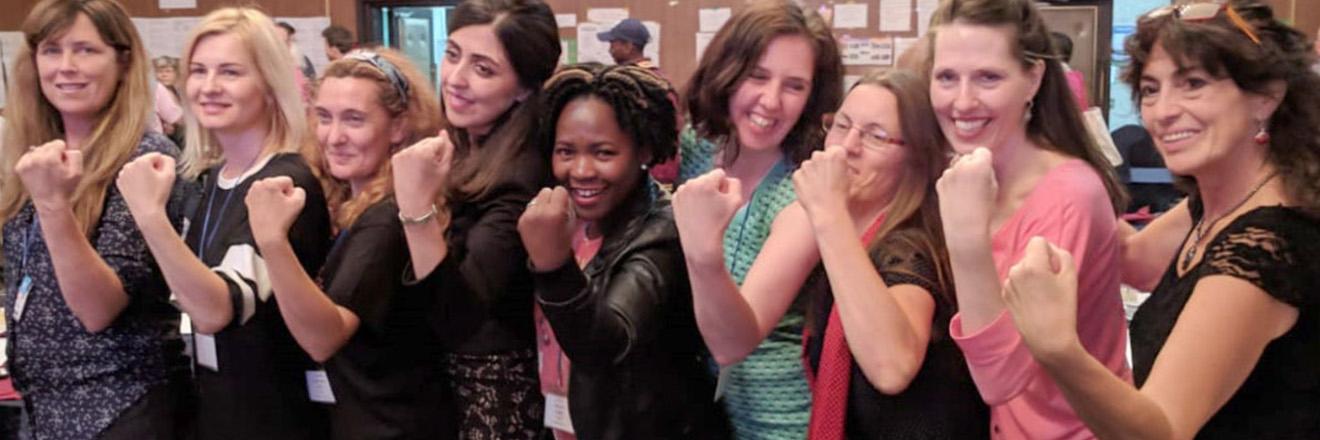 Row of women in defiant pose 