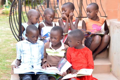 Seven young children seated on a step